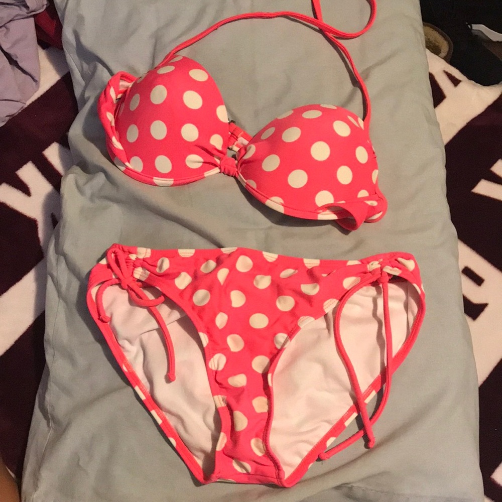 A pink bathing suit with white polkadots